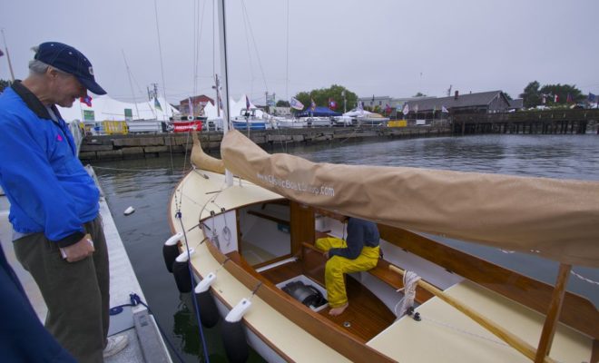 A young man demonstating a soundless electric drive at the 2013 Maine Boats, Homes & Harbors Show in Rockland.