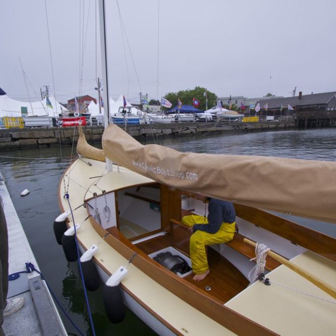 A young man demonstating a soundless electric drive at the 2013 Maine Boats, Homes & Harbors Show in Rockland.