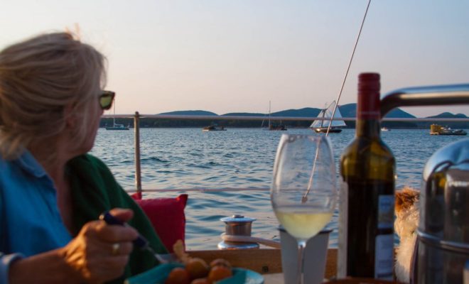 A Friendship Sloop reaching out of Hadlock Cove on Little Cranberry, is a pleasant dining distraction.