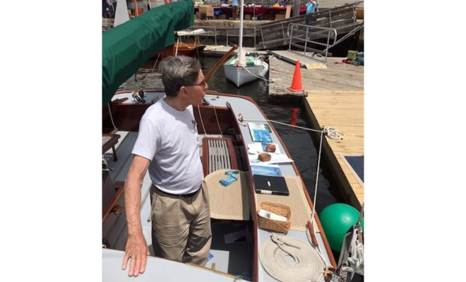 Bill Fortenbaugh, original owner of Ghost, greets visitors at the Mystic Seaport's Wooden Boat Show. Photo by Gretchen Coyle