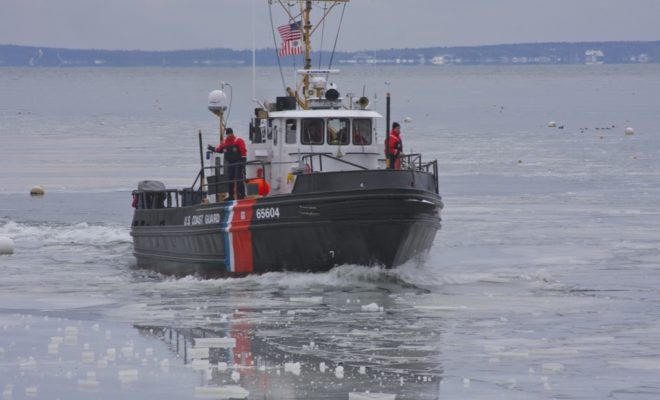 The ice breaker TACKLE out of Rockland Harbor enters ice-choked Rockport Harbor.