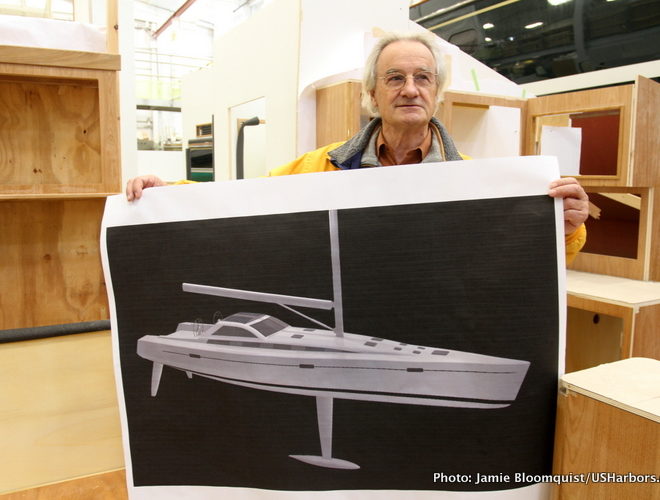 Dr. Stanley Paris holds a rendering of KIWI SPIRIT, the yacht in which he will try to break one of the great sailing records.