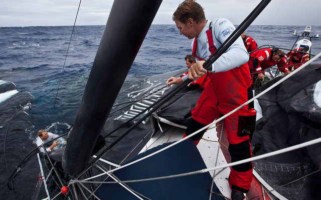Skipper Ken Read, at right, oversees the recovery of the mainsail. Photo by Amory Ross/PUMA Ocean Racing powered by BERG