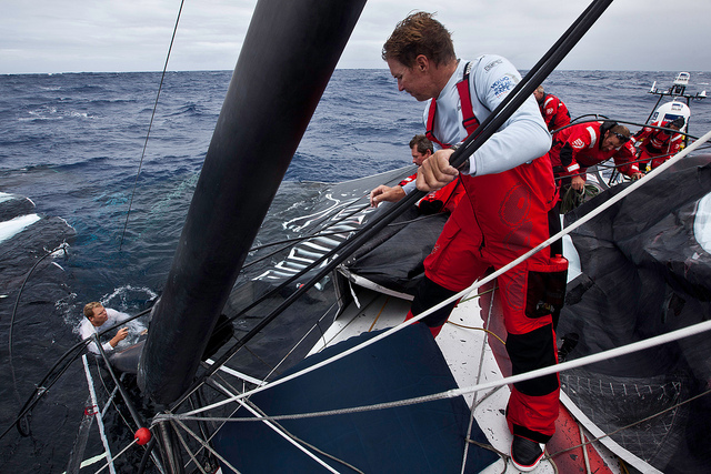 Skipper Ken Read, at right, oversees the recovery of the mainsail. Photo by Amory Ross/PUMA Ocean Racing powered by BERG