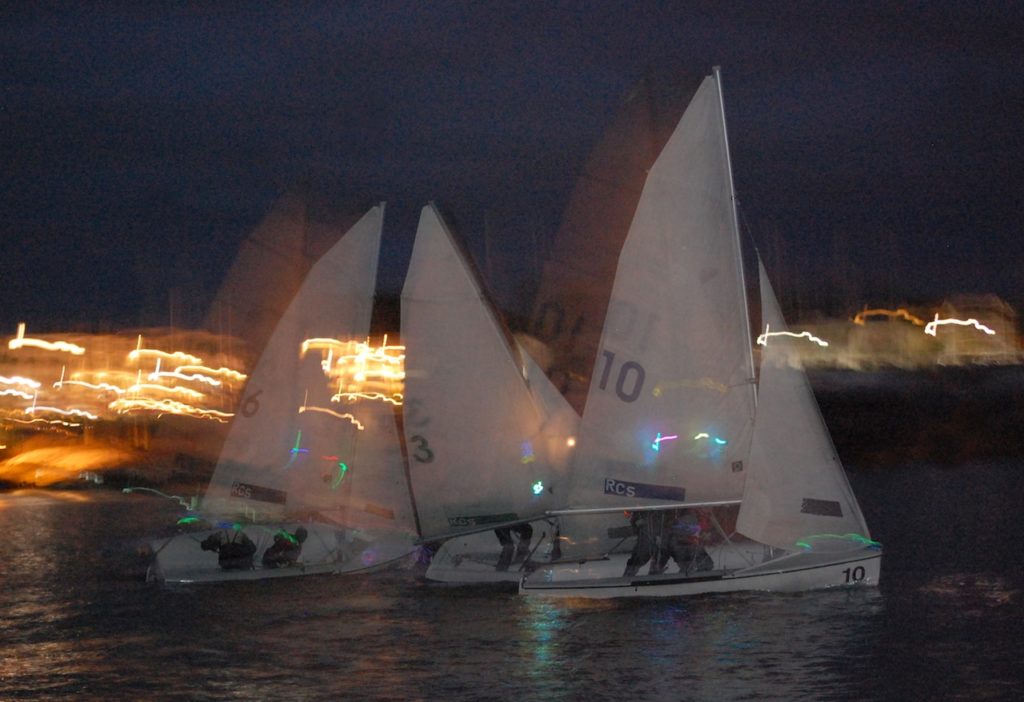 Racing with the lights of Rockland in the background. Photo by Michael O'Neil