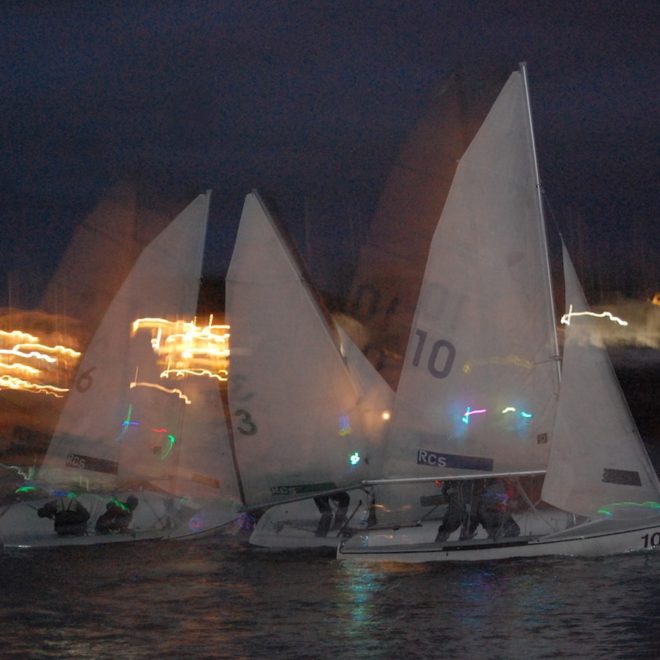 Racing with the lights of Rockland in the background. Photo by Michael O'Neil