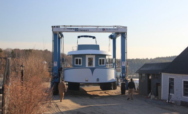The houseboat NANCY LOU, being launched April 9 in Riggs Cove. NANCY LOU and two other houseboats are available for rent.