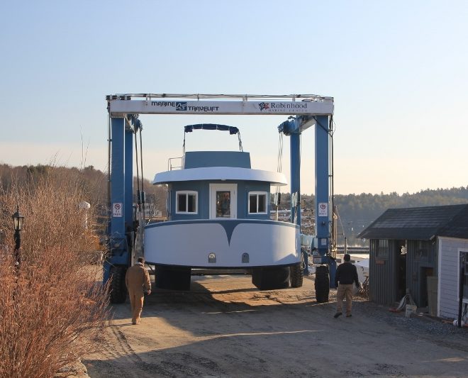 The houseboat NANCY LOU, being launched April 9 in Riggs Cove. NANCY LOU and two other houseboats are available for rent.