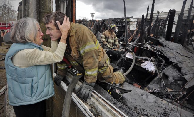 Ruth Nicolaci and her volunteer firefighter son G. Bourne Knowles after fighting a fire at his parents' business