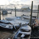 Snow-covered skiffs on Jonesport's working waterfront.