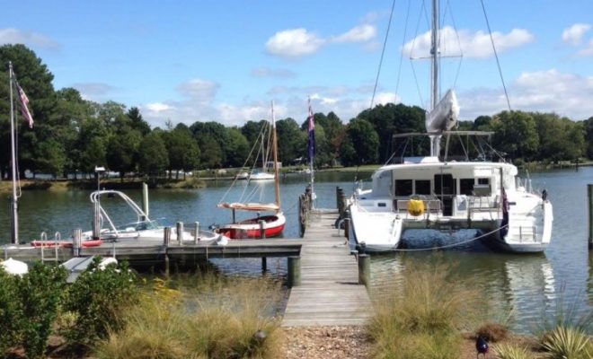 A classic Arey's Pond Boat Yard cat, at left, sits on the Chesapeake beside a modern cruising catamaran.