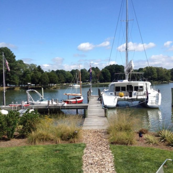 A classic Arey's Pond Boat Yard cat, at left, sits on the Chesapeake beside a modern cruising catamaran.