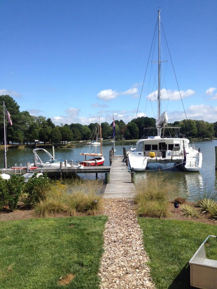 A classic Arey's Pond Boat Yard cat, at left, sits on the Chesapeake beside a modern cruising catamaran.