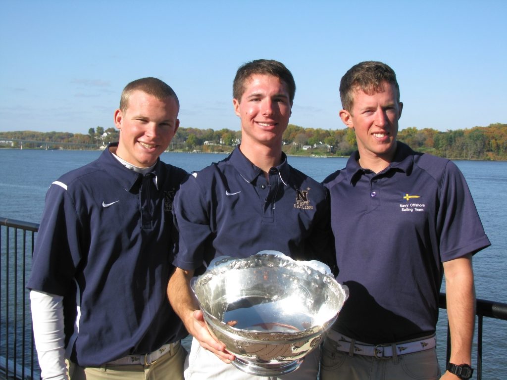 Former RCS sailor Dillon Rossiter holding college championship JFK Cup with Naval Academy crew.