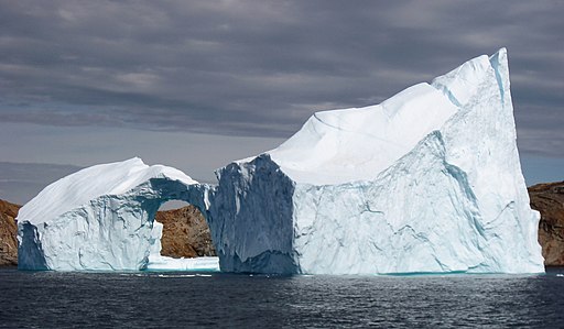 Kim Hansen, CC BY-SA 3.0 <https://creativecommons.org/licenses/by-sa/3.0>, Iceberg_with_hole_near_sanderson_hope_2007-07-28_1 via Wikimedia Commons