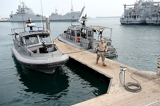 U.S. Navy photo by Mass Communication Specialist 1st Class Krishna M. Jackson, Public domain, US_Navy_120107-N-RP435-486_Boatswain's_Mate_3rd_Class_Moulton_LeBlanc_moors_a_U.S._Navy_coastal_patrol_boat_after_a_patrol_of_Kuwait_Naval_Base's_h via Wikimedia Commons