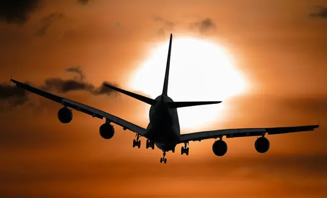 Shadow image of a plane flying at sunset. Climate change may make future airline flights bumpier. Credit: Photo by Pixabay from Pexels (CC0 1.0)