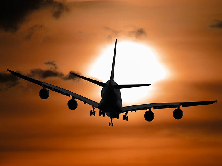 Shadow image of a plane flying at sunset. Climate change may make future airline flights bumpier. Credit: Photo by Pixabay from Pexels (CC0 1.0)