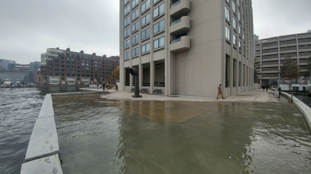 High tide flooding pushes water onto a walkway along the Boston waterfront near India Wharf in 2016. (Image credit: Courtesy of MyCoast.org)