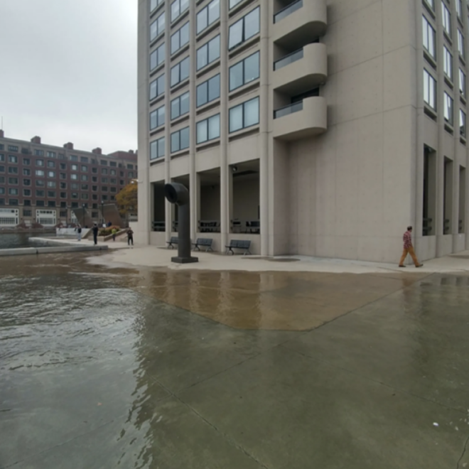 High tide flooding pushes water onto a walkway along the Boston waterfront near India Wharf in 2016. (Image credit: Courtesy of MyCoast.org)