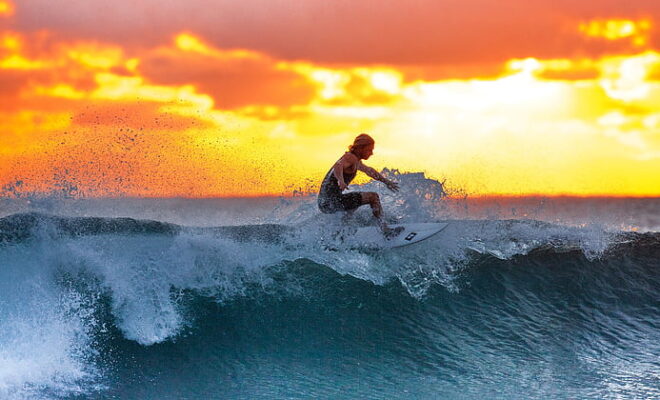 Woman surfing during sunset | PickPik