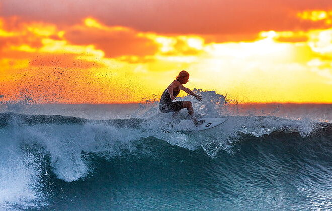 Woman surfing during sunset | PickPik