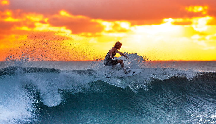 Woman surfing during sunset | PickPik