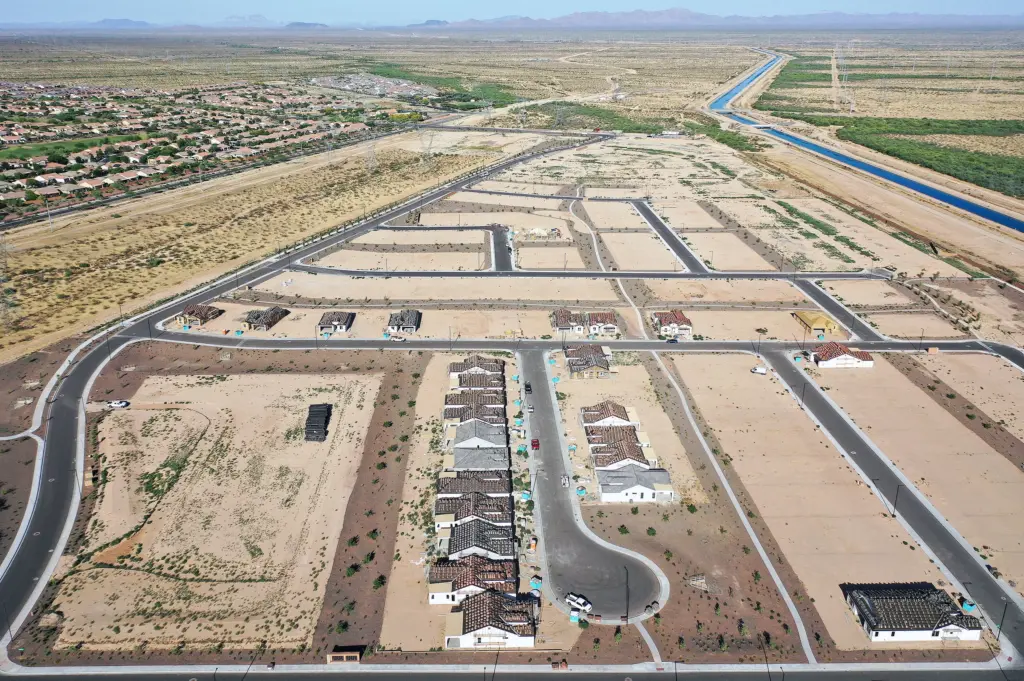 New homes are under construction in June at a housing development near Buckeye, Ariz. A growing number of local governments are considering limits on homebuilding in the face of floods, droughts and wildfires driven by climate change. Mario Tama/Getty Images