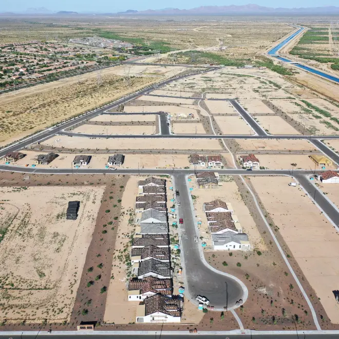 New homes are under construction in June at a housing development near Buckeye, Ariz. A growing number of local governments are considering limits on homebuilding in the face of floods, droughts and wildfires driven by climate change. Mario Tama/Getty Images