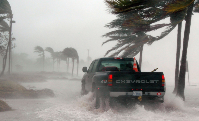 Truck in coastal flooding and storm. Image by Canva.