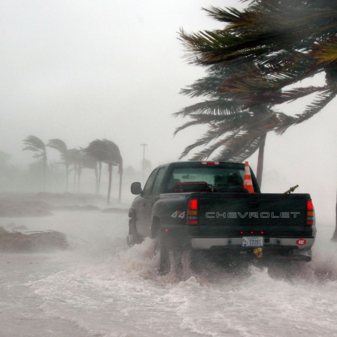 Truck in coastal flooding and storm. Image by Canva.