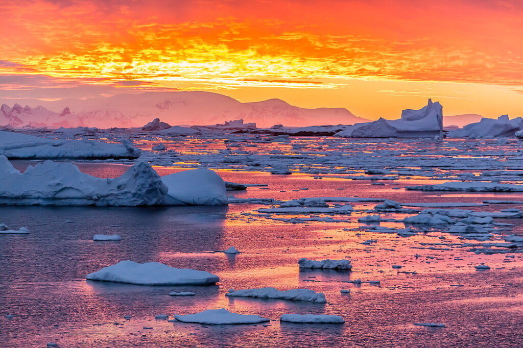71319675-Sunset-over-ice-floes-and-icebergs-near-Pleneau-Island-Antarctica-Southern-Ocean-Polar-Regions