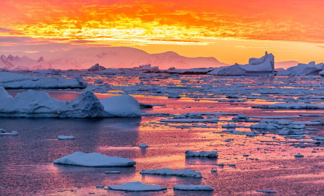 71319675-Sunset-over-ice-floes-and-icebergs-near-Pleneau-Island-Antarctica-Southern-Ocean-Polar-Regions