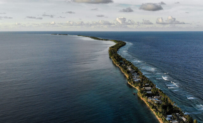 The land between lagoon and beach in Funafuti, Tuvalu. The highest point on Tuvalu is 4.6 metres above sea level. With five millimetres per year of regional sea level rise (above the global average), the small nation could be inundated within a century. Credit: Mario Tama / Getty Images