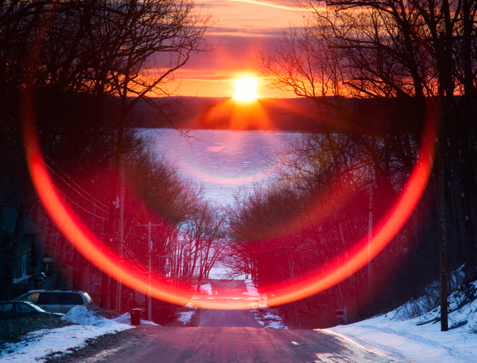 Sunset on a road with frozen lake in front. Image from Canva.com