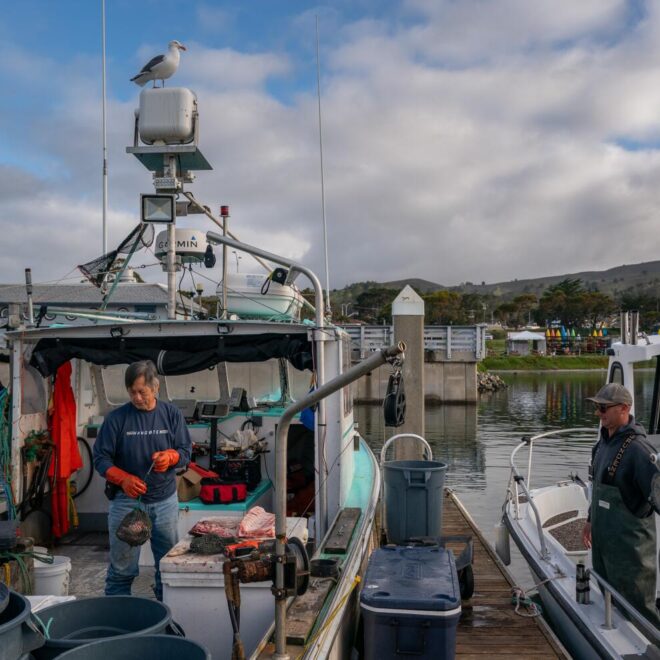 Commercial fishermen George Jue, left, and Dan St. Clair work at Pillar Point Harbor in Half Moon Bay.