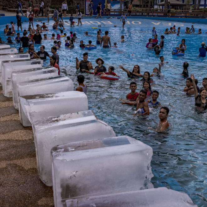 MARILAO, PHILIPPINES - MAY 04, 2024: Workers prepare to dump blocks of ice at a pool amid extreme heat in Marilao, Bulacan province. Sweltering conditions strained power grids, sparked health warnings, and left residents desperate for ways to stay cool. May 2024 was the world's warmest May on record. (Image credit: Ezra Acayan/Getty Images)