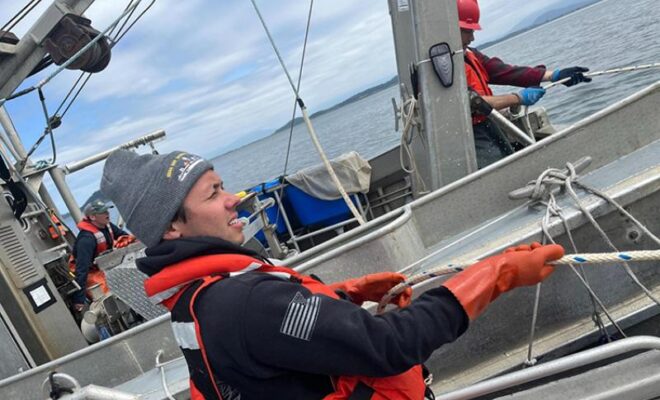 Image Credits: Former NOAA veteran intern Garret Engelke pulls in a surface trawling net on the Puget Sound with NOAA scientists.