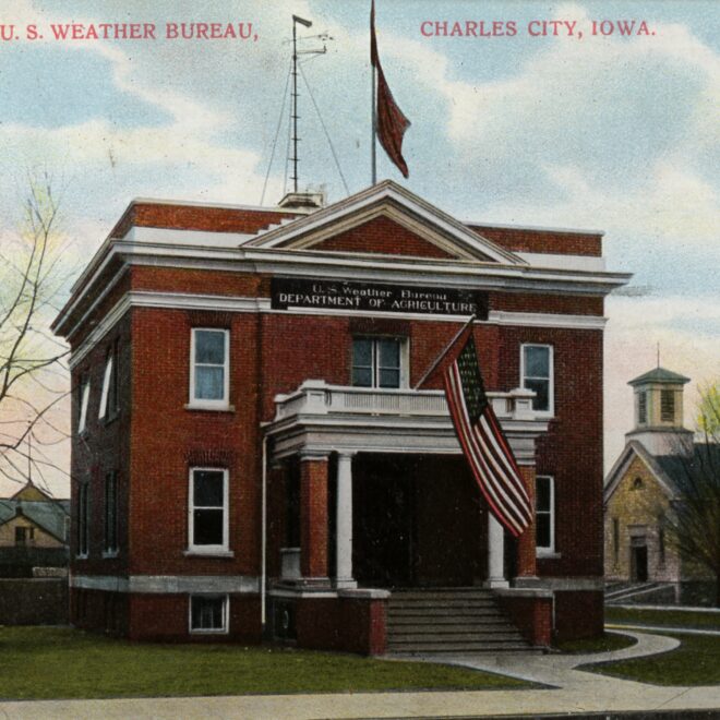 Image Credits: Postcard of the U.S. Weather Bureau Building at Charles City, Iowa. c. 1900. Note the Weather Forecast Flag system flags flown on the flag pole mounted on the roof. They appear to be the blue flag with a black pennant above, indicating a forecast of higher temperatures and rain. (Image credit: Courtesy of Steve Doty, NOAA NCDC (ret.))