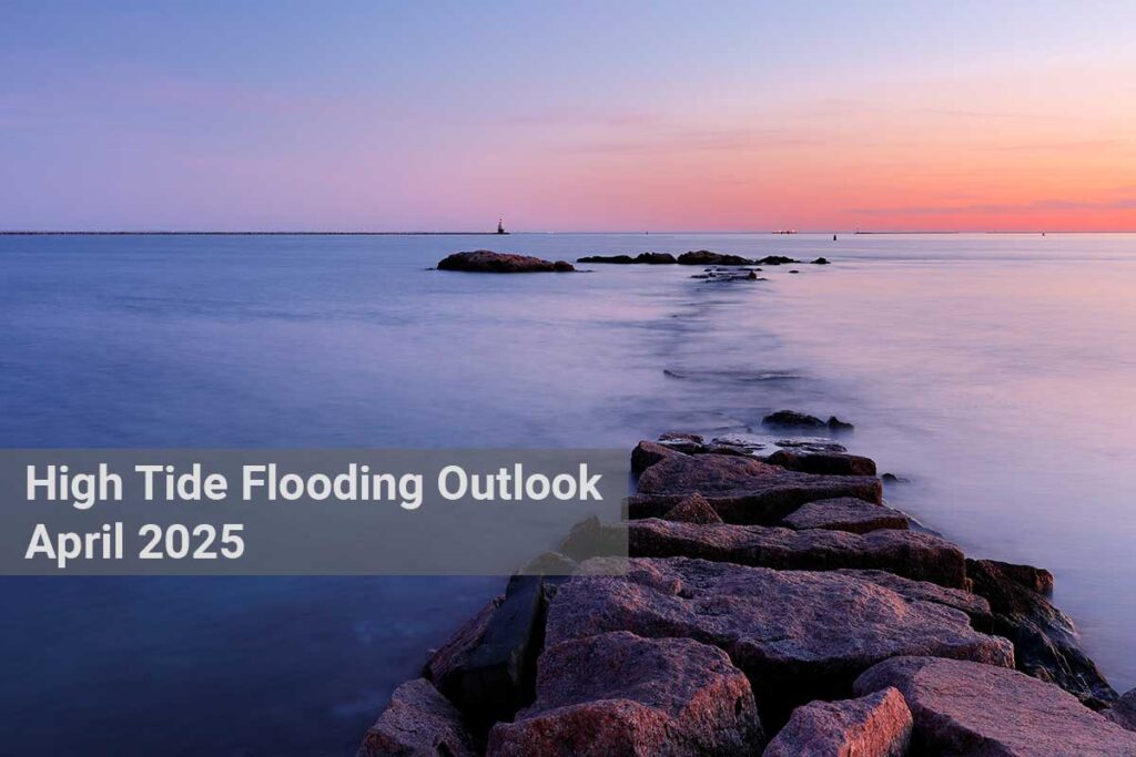 High tide flooding over a rock jetty at sunset