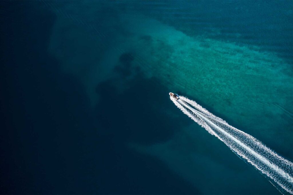 Aerial view of a powerboat running in shallow water.