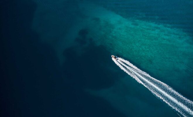 Aerial view of a powerboat running in shallow water.