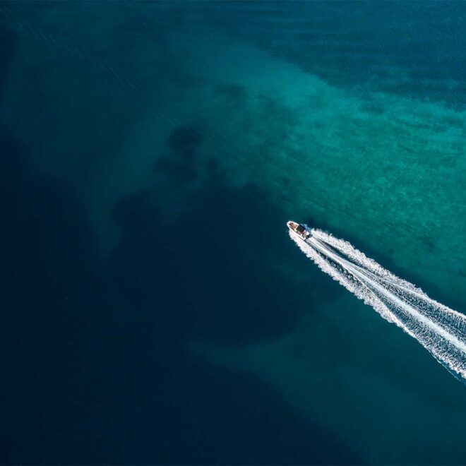 Aerial view of a powerboat running in shallow water.
