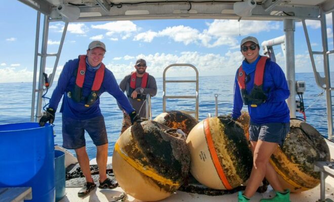 The NOAA Florida Keys National Marine Sanctuary Buoy Team performs maintenance on boundary buoys for Carysfort Reef Sanctuary Preservation Area. Photo: Brittany Torres/NOAA