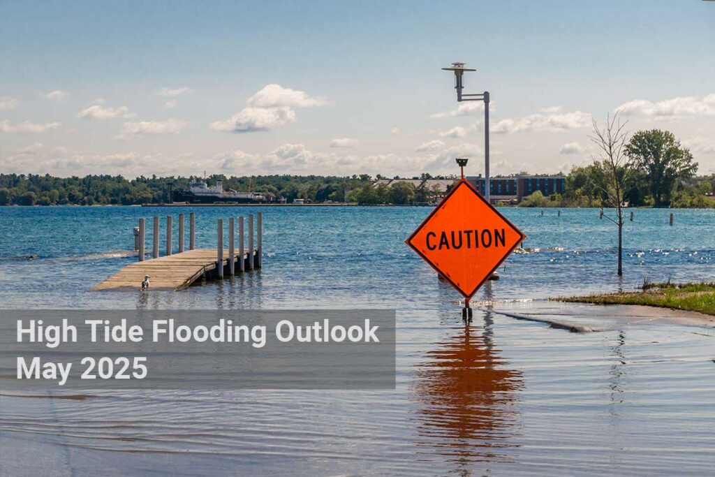 Flooding water at boat ramp. Bright orange caution sign