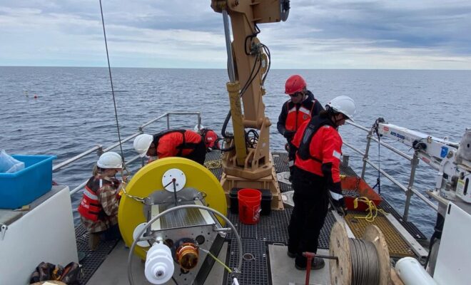 NOAA and University of Wisconsin-Milwaukee researchers prepare a new real-time weather buoy for deployment in Wisconsin Shipwreck Coast National Marine Sanctuary. Photo: NOAA