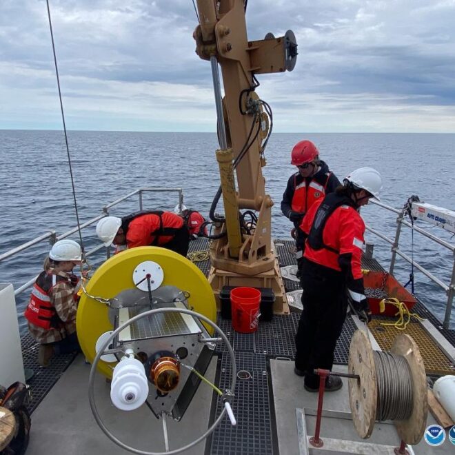 NOAA and University of Wisconsin-Milwaukee researchers prepare a new real-time weather buoy for deployment in Wisconsin Shipwreck Coast National Marine Sanctuary. Photo: NOAA
