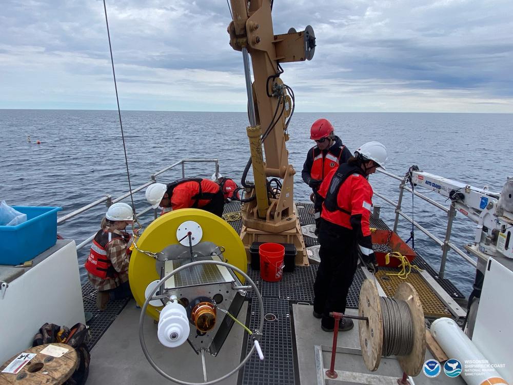 NOAA and University of Wisconsin-Milwaukee researchers prepare a new real-time weather buoy for deployment in Wisconsin Shipwreck Coast National Marine Sanctuary. Photo: NOAA