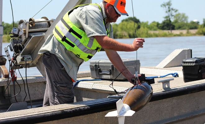 Lane Simmons of the U.S. Geological Survey collects a water-quality sample at the Mississippi River at Baton Rouge, Louisiana (USGS 07374000). Credit: Scott Dennis, USGS.
