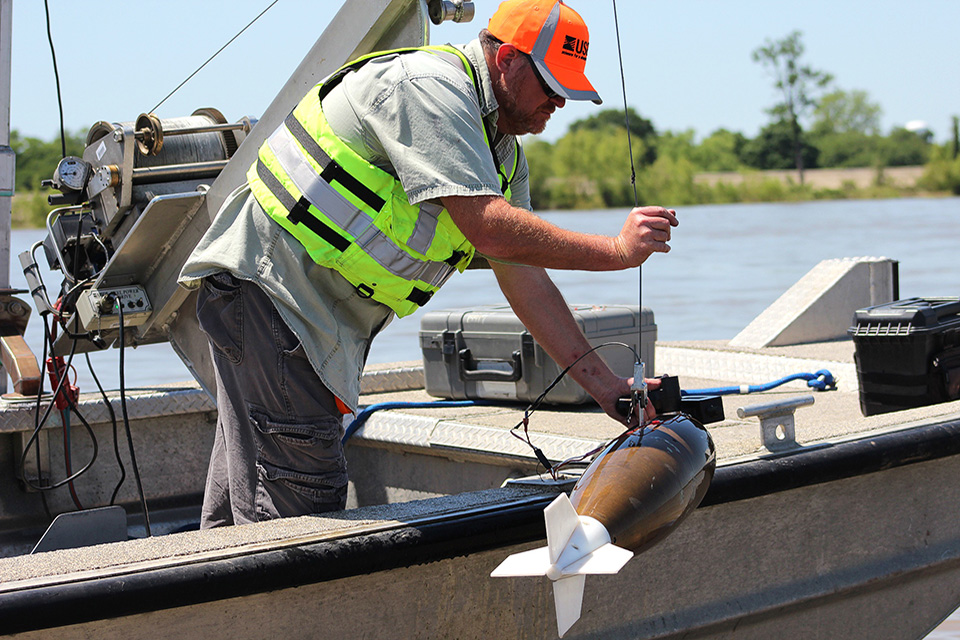 Lane Simmons of the U.S. Geological Survey collects a water-quality sample at the Mississippi River at Baton Rouge, Louisiana (USGS 07374000). Credit: Scott Dennis, USGS.